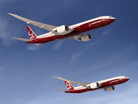 Renderings of two red-and-white planes -- the Boeing 777-8 and 777-9 -- flying side by side under blue skies
