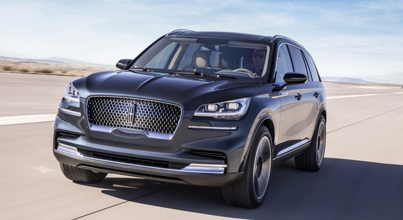 A front view of the Aviator, a dark gray luxury crossover SUV, on a desert road.