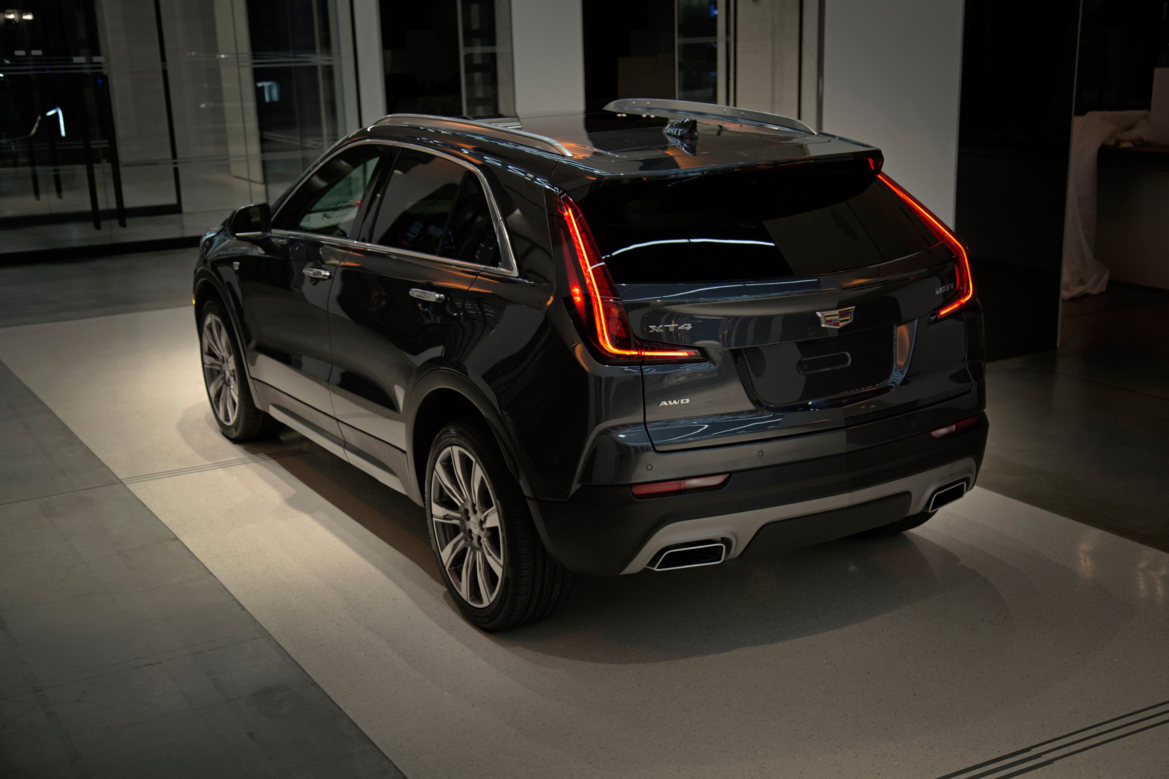 A dark gray 2019 Cadillac XT4 in Premium Luxury trim, shown at Cadillac House in New York. 