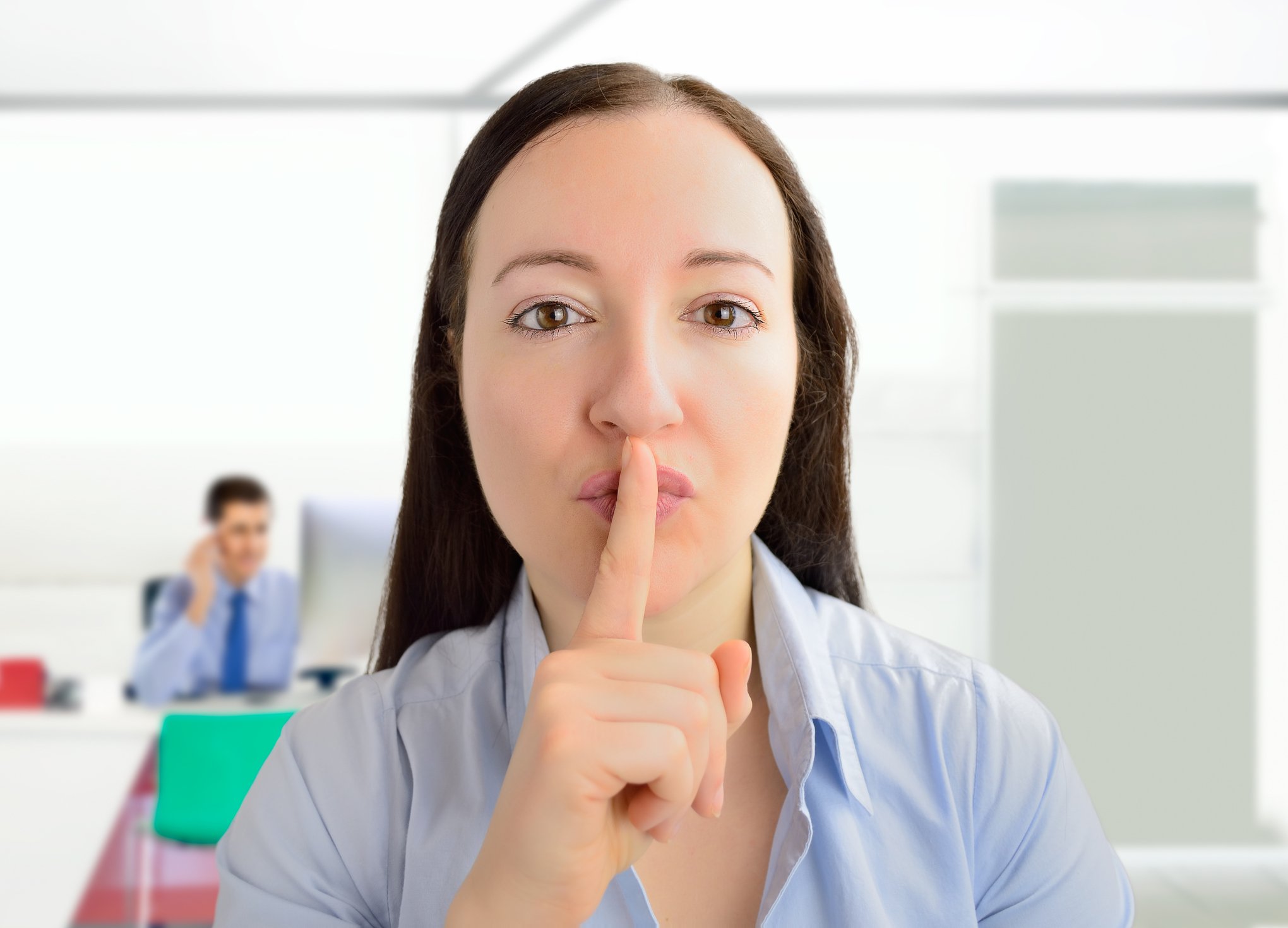Woman putting a finger to her lips