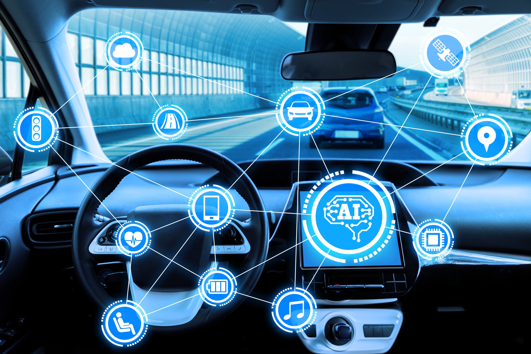 Front view from inside a vehicle that's driving on a 4-lane divided highway that has nobody sitting in driver's seat -- an autonomous vehicle. 