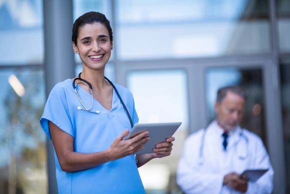 A woman doctor standing in a hallway.