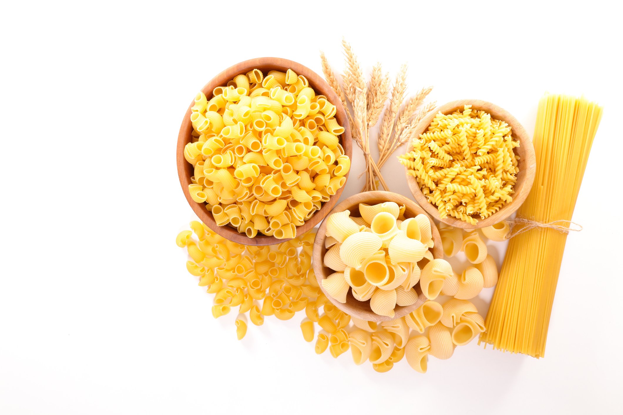 Various types of dried pasta in small bowls