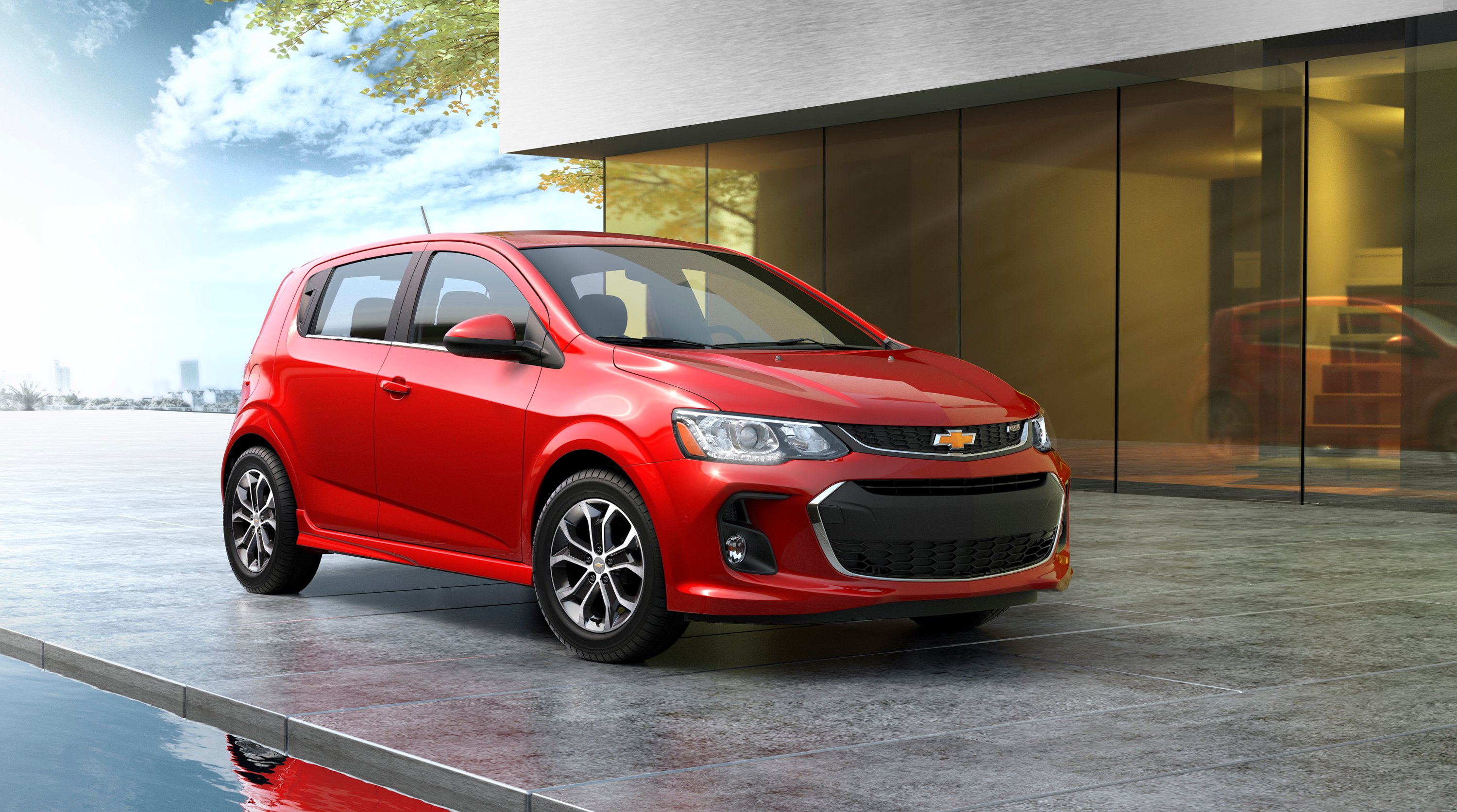 A red 2017 Chevrolet Sonic, a small hatchback
