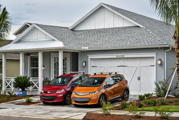 Two Bolt vehicles sitting in a driveway