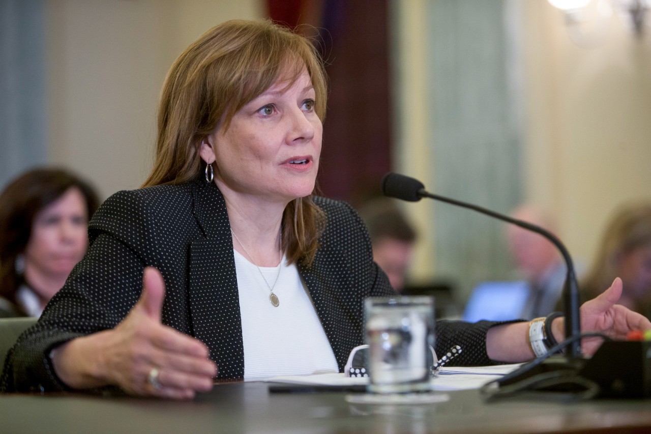 GM CEO Mary Barra is shown seated at a table in a U.S. Senate conference chamber. 