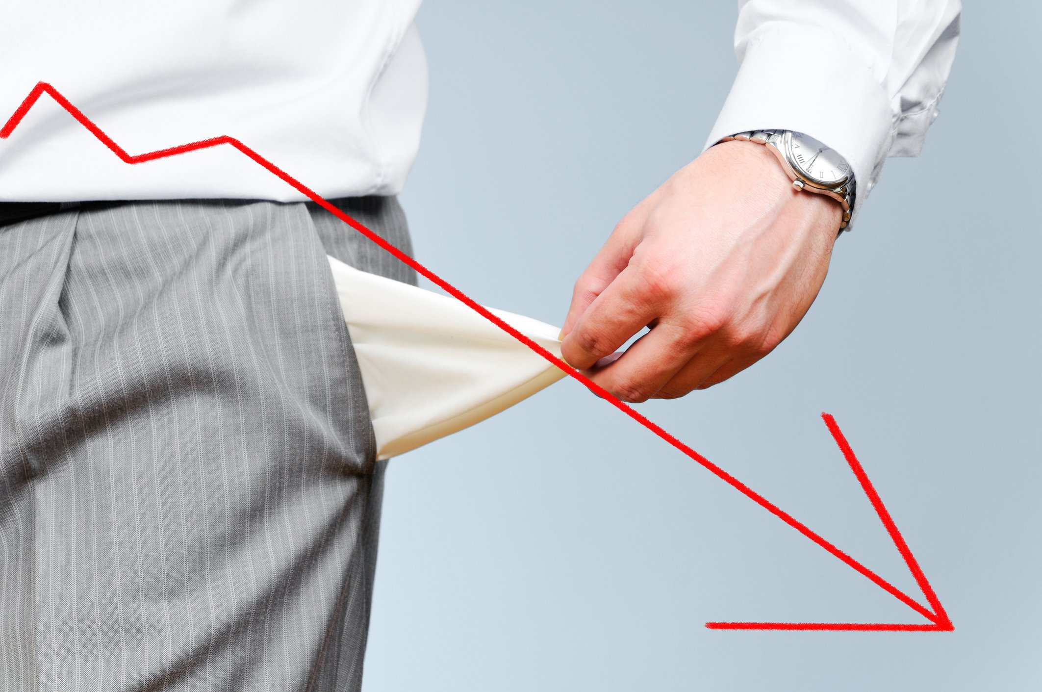 A picture of a man emptying his pockets with a downward trending arrow drawn in front.