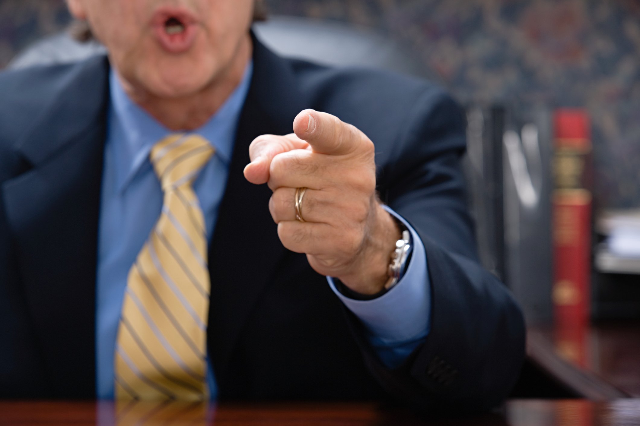 Man in suit pointing