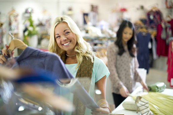 A young woman shops for clothes.