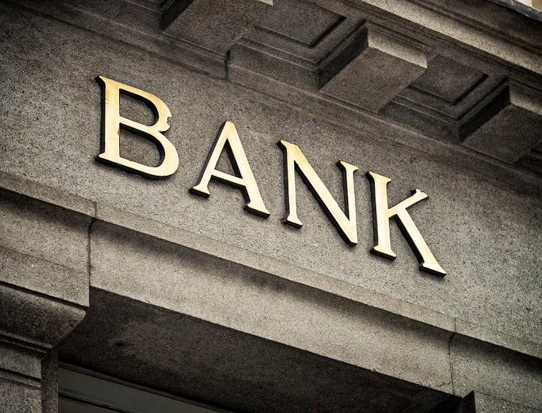 Letters spelling out "bank" on a marble building.
