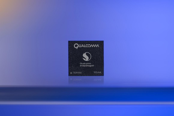 A Qualcomm Snapdragon processor with a purple backdrop.
