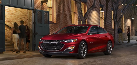 A red 2019 Chevrolet Malibu, a midsize sedan, parked on a city street.