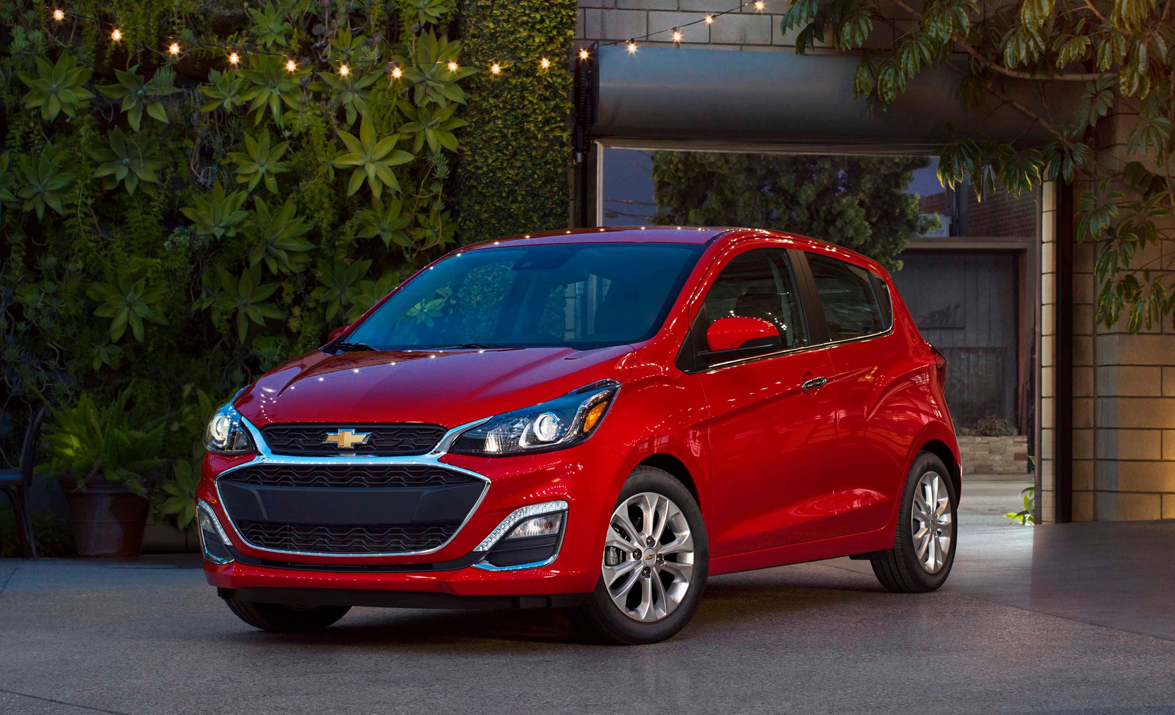 A red 2019 Chevrolet Spark, a very small hatchback. 
