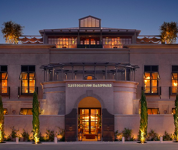 A Restoration Hardware storefront at dusk.