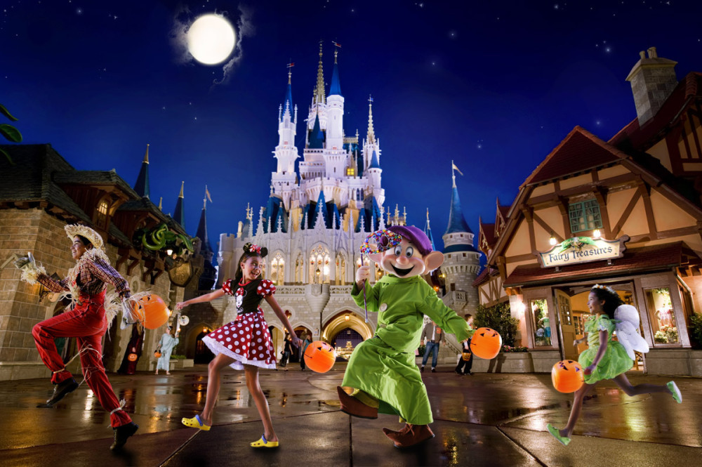 A person in a Dopey costume, a girl in a Minnie Mouse dress, and two other people skipping with the Magic Kingdom castle in the background.
