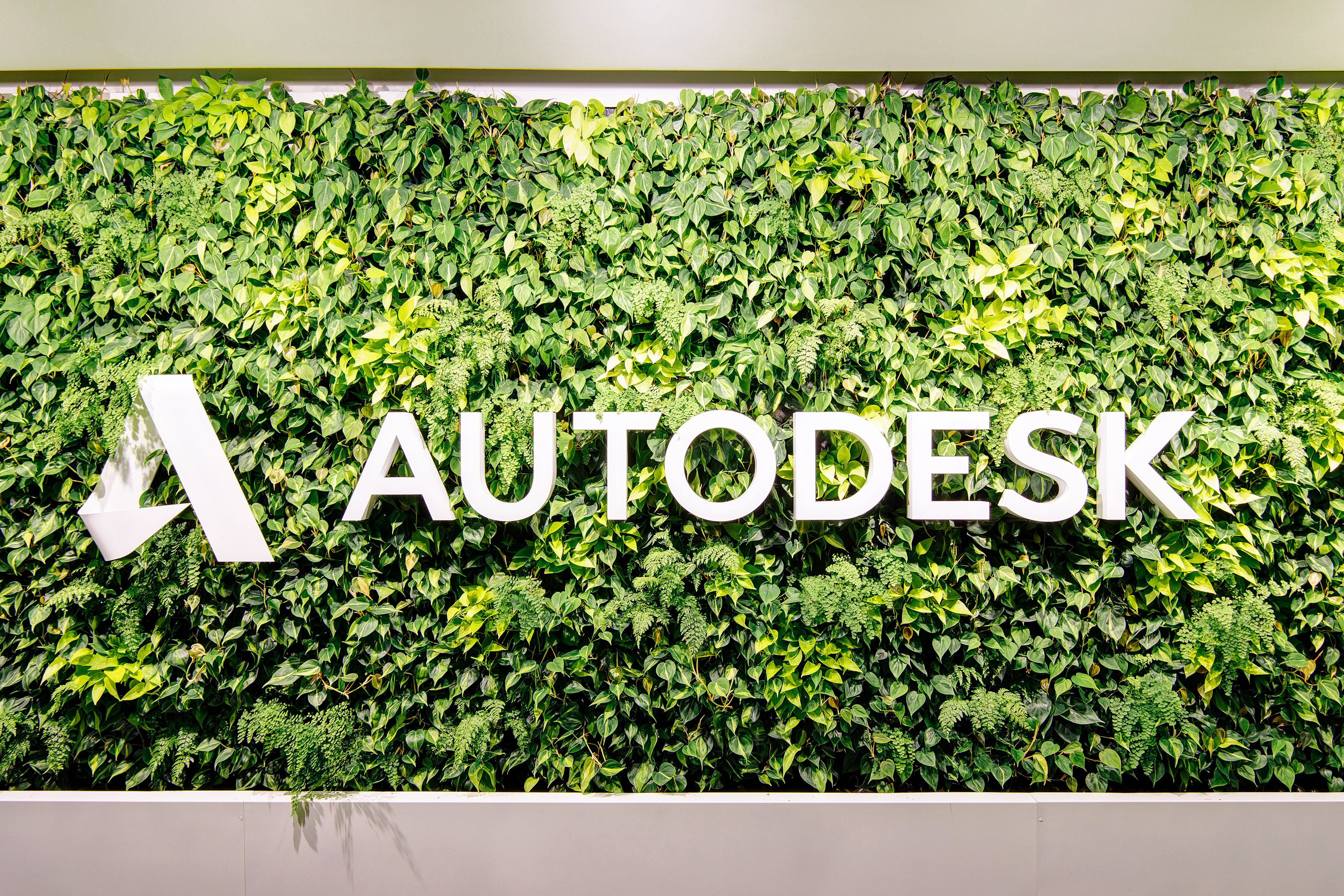 Autodesk logo and sign surrounded by greenery.