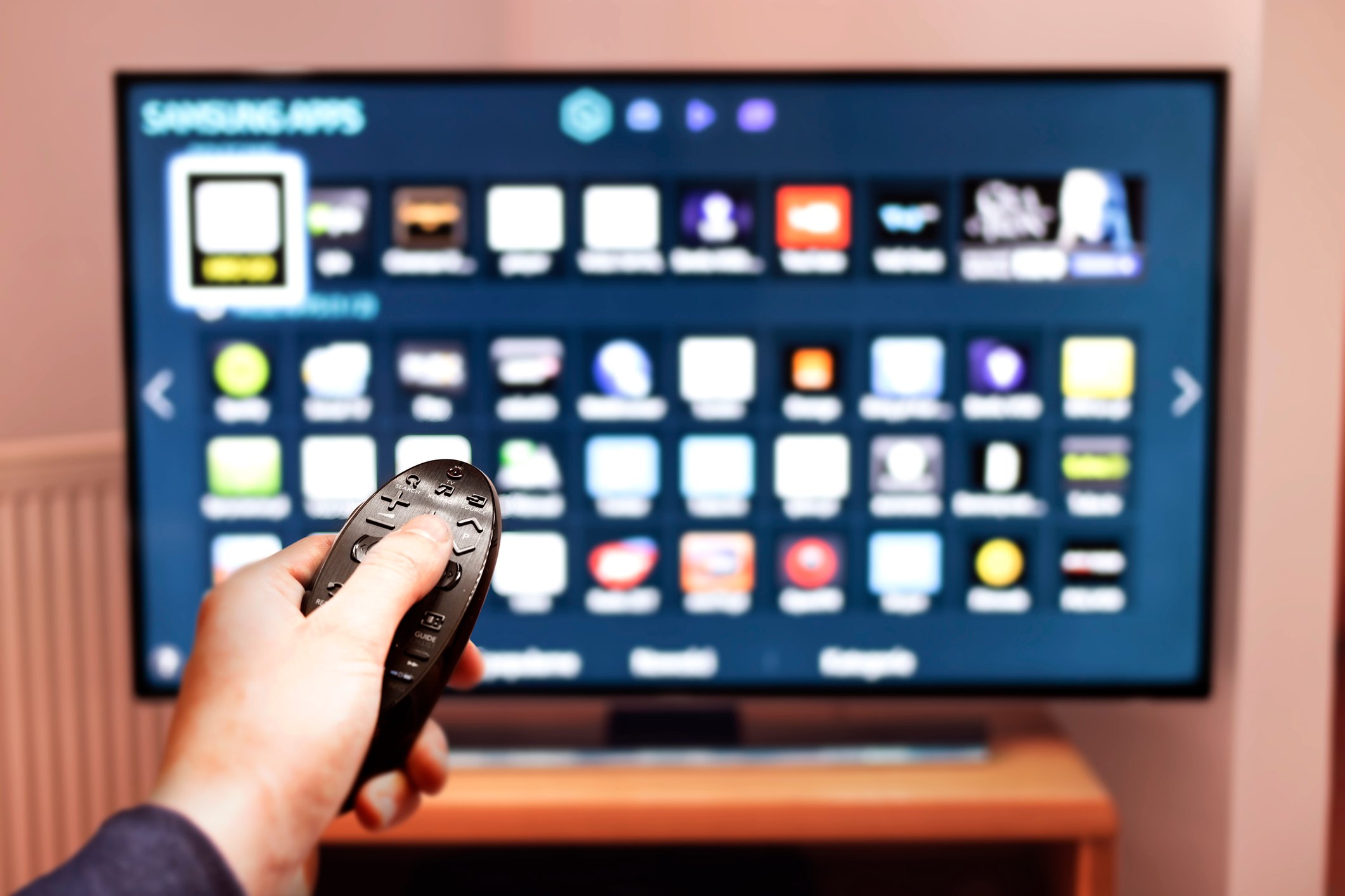 A man browses programs on a smart TV.