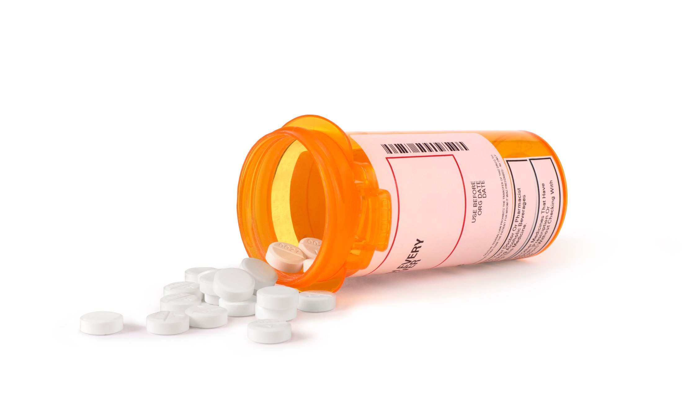 White tablets spilling from a prescription bottle.