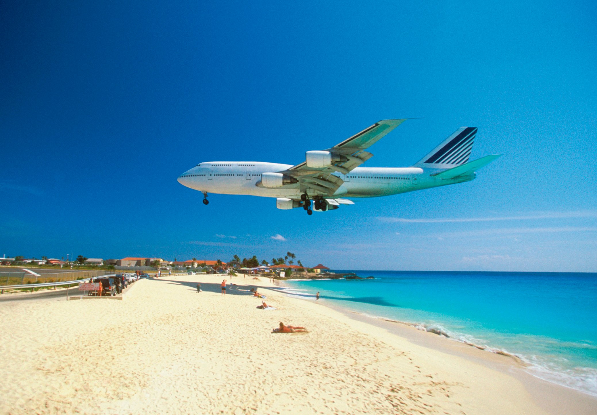 Airplane coming in for a landing just above the sunny beaches of St. Maarten.