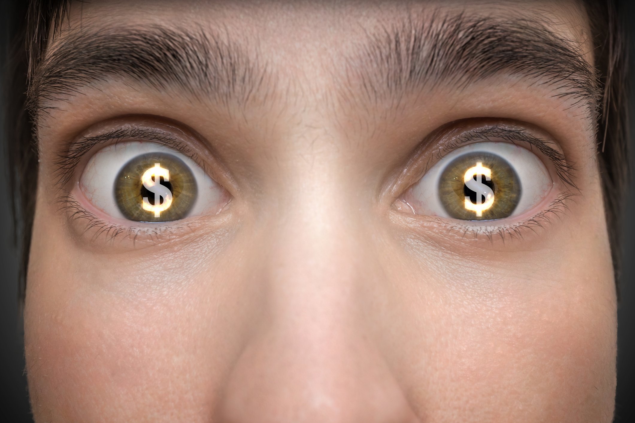 Dollar signs in eyes of young person