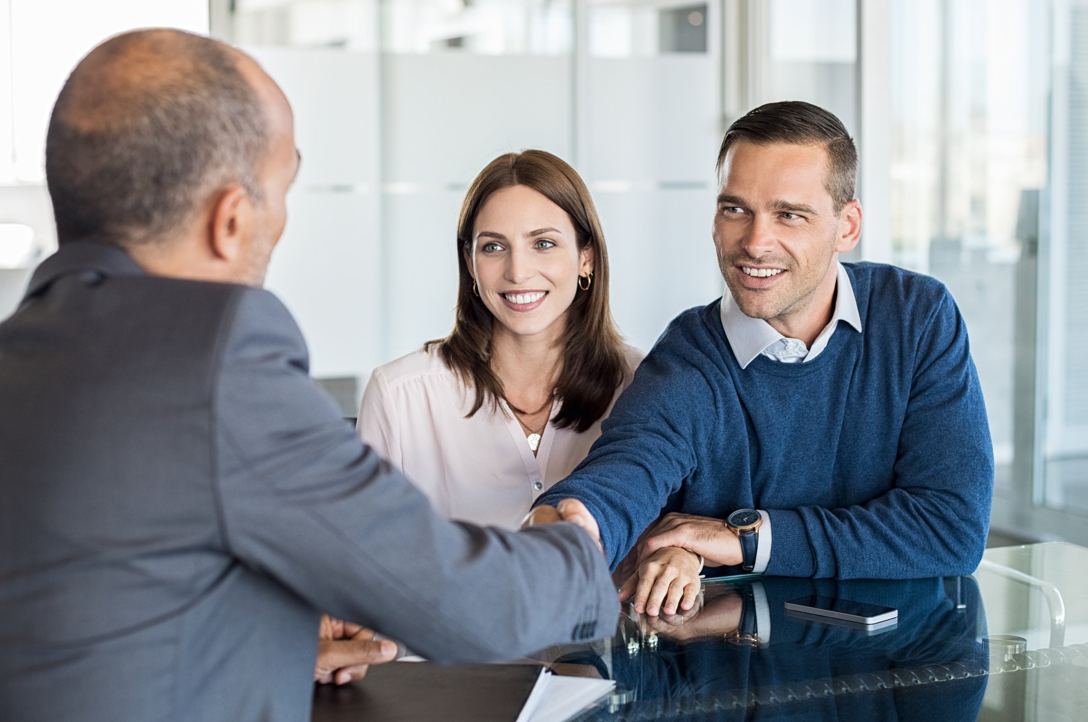 Couple sitting across from man in suit