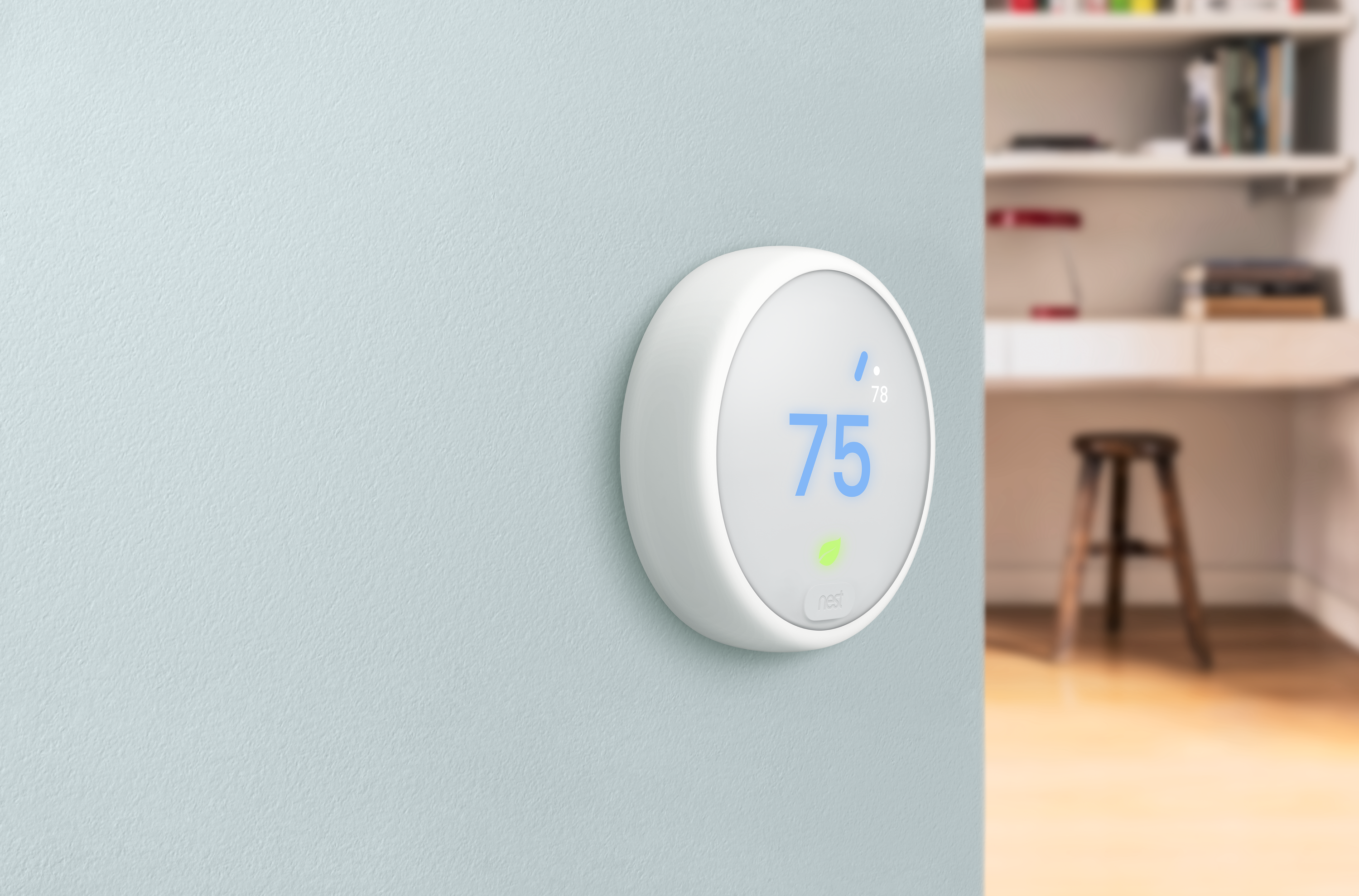Nest smart thermostat on a wall