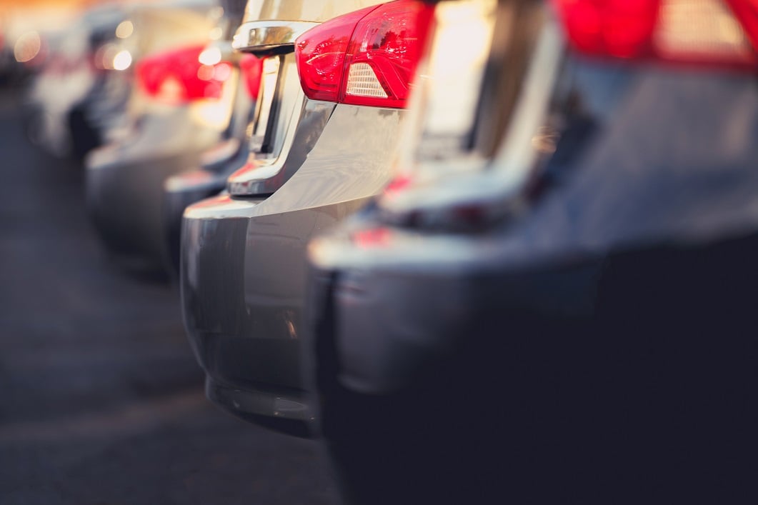 Cars lined up in a dealer lot.