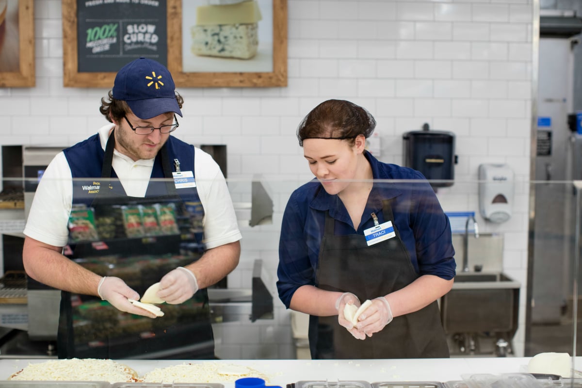 WalMart workers are preparing food.