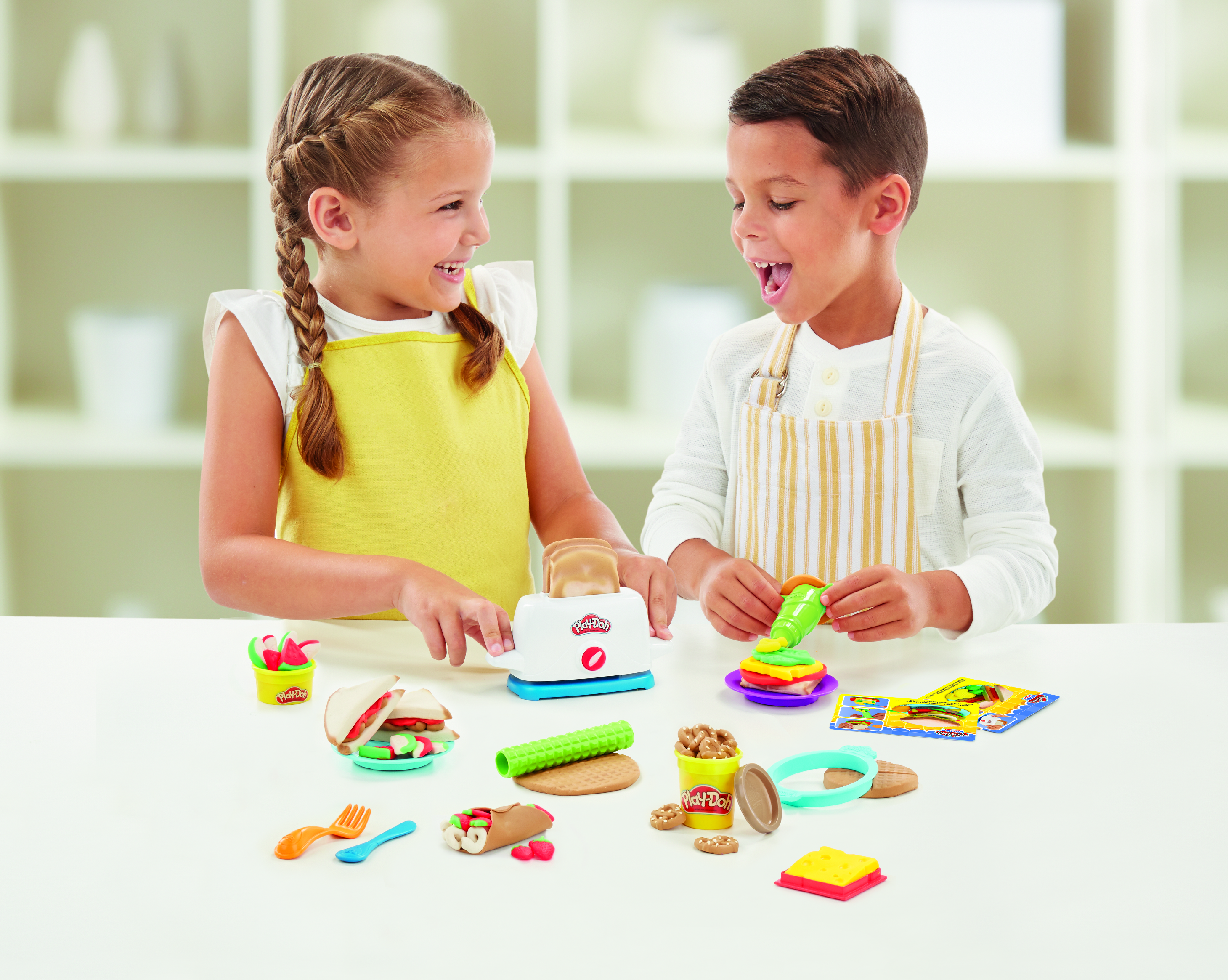 A girl and a boy playing with Play-Doh.