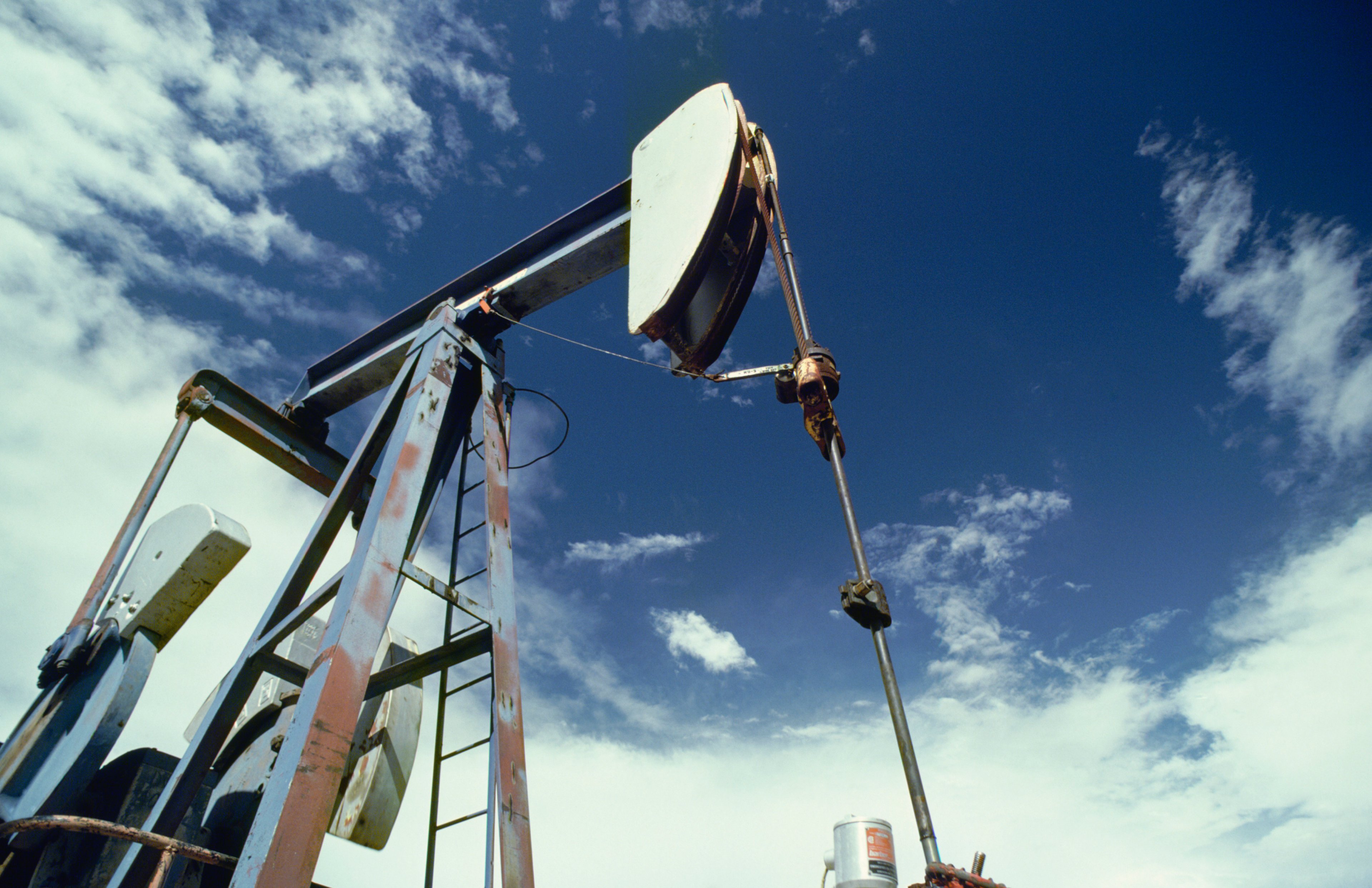 An oil pump looking up into the blue sky.