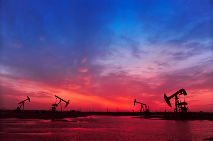 Oil pumps in silhouette against an evening sky