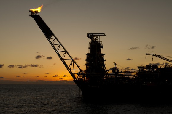 A floating production, storage, and offloading facility at dusk.