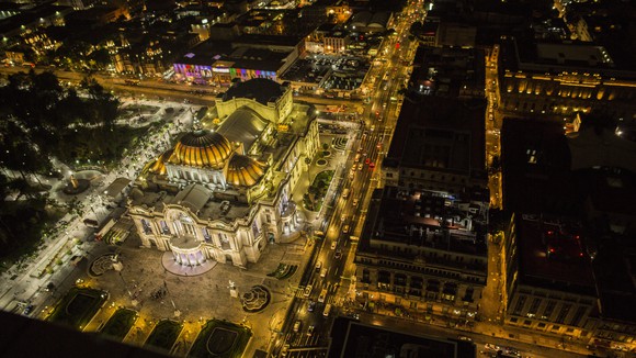 Overhead night image of the illuminated Palacio De Bella Artes, Mexico City