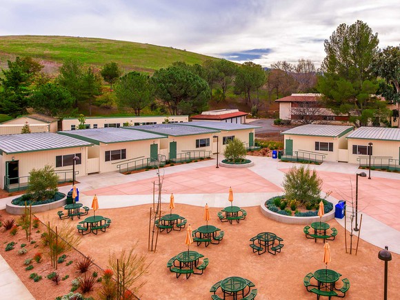 An ariel view of the courtyard of a school with modular buildings. 