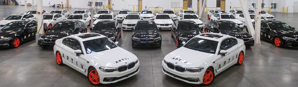 Fleet of parked Aptiv/Lyft partnered vehicles.