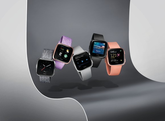 Five of Fitbit's Versa smartwatches.