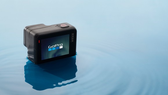 GoPro HERO camera sitting in shallow blue water