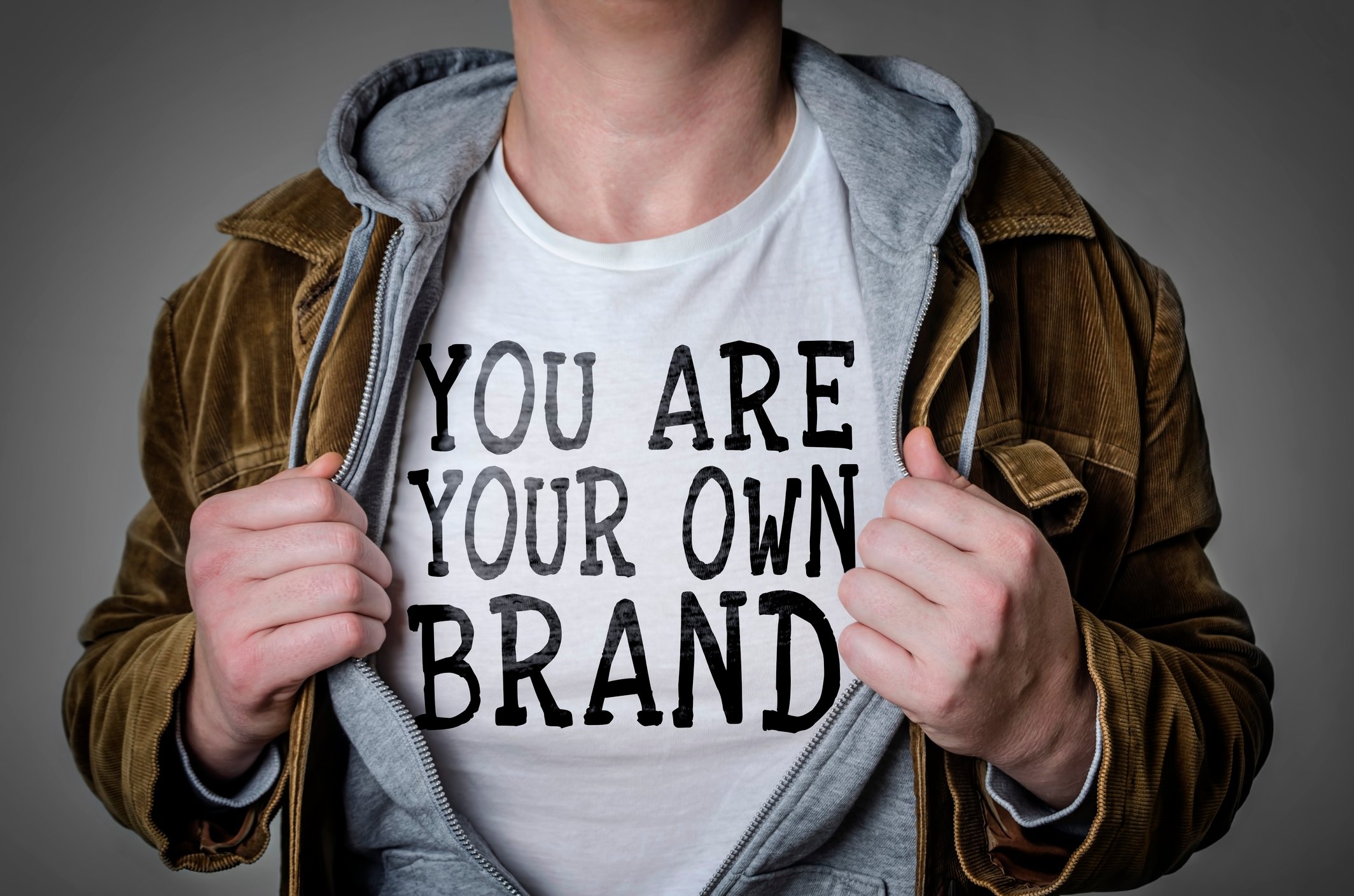 A man wears a shirt that says you are your own personal brand.