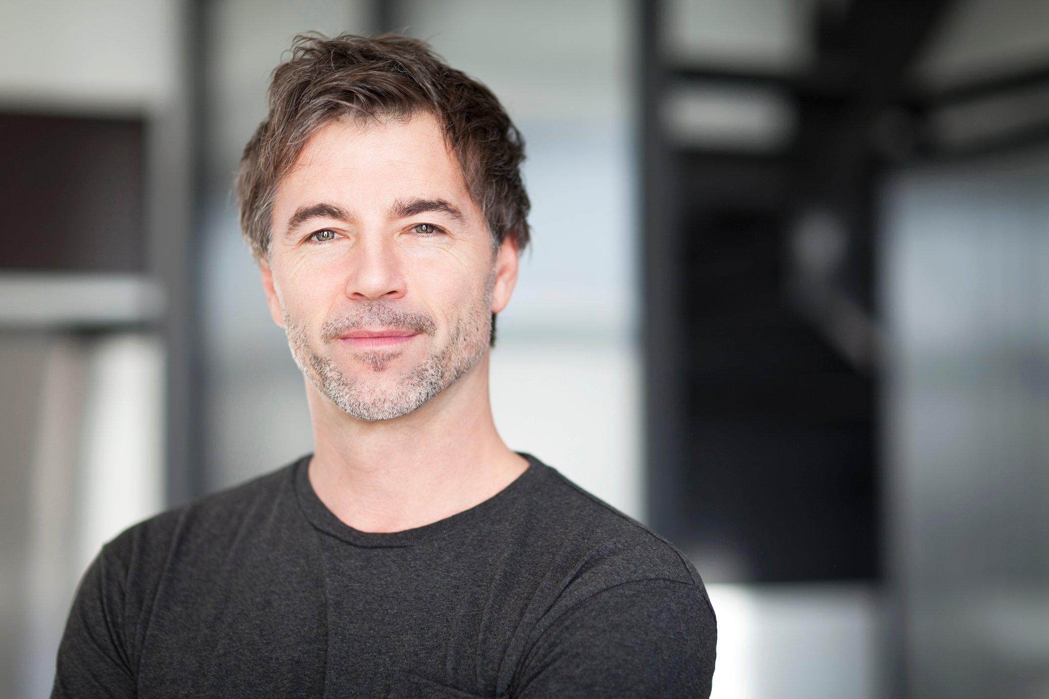 Slightly grinning young man.