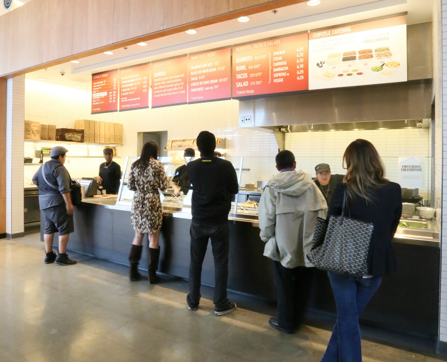 People are in line at a Chipotle.