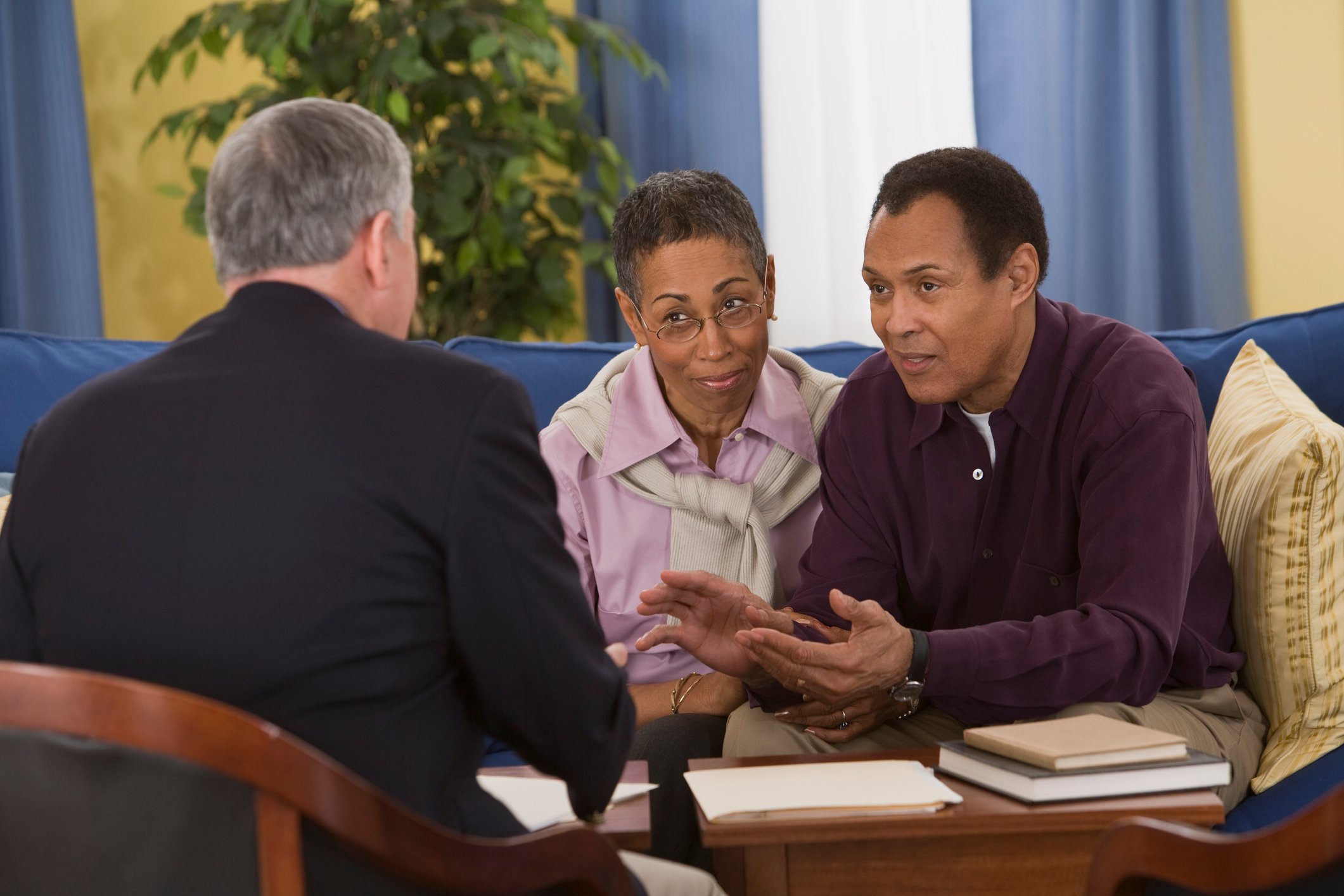 Couple sitting across from a man in a suit