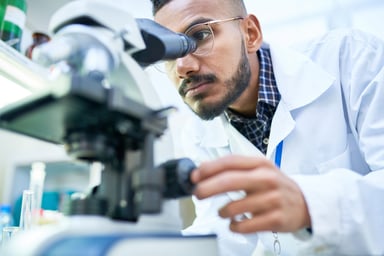 Scientist-using-microscope-laboratory-getty