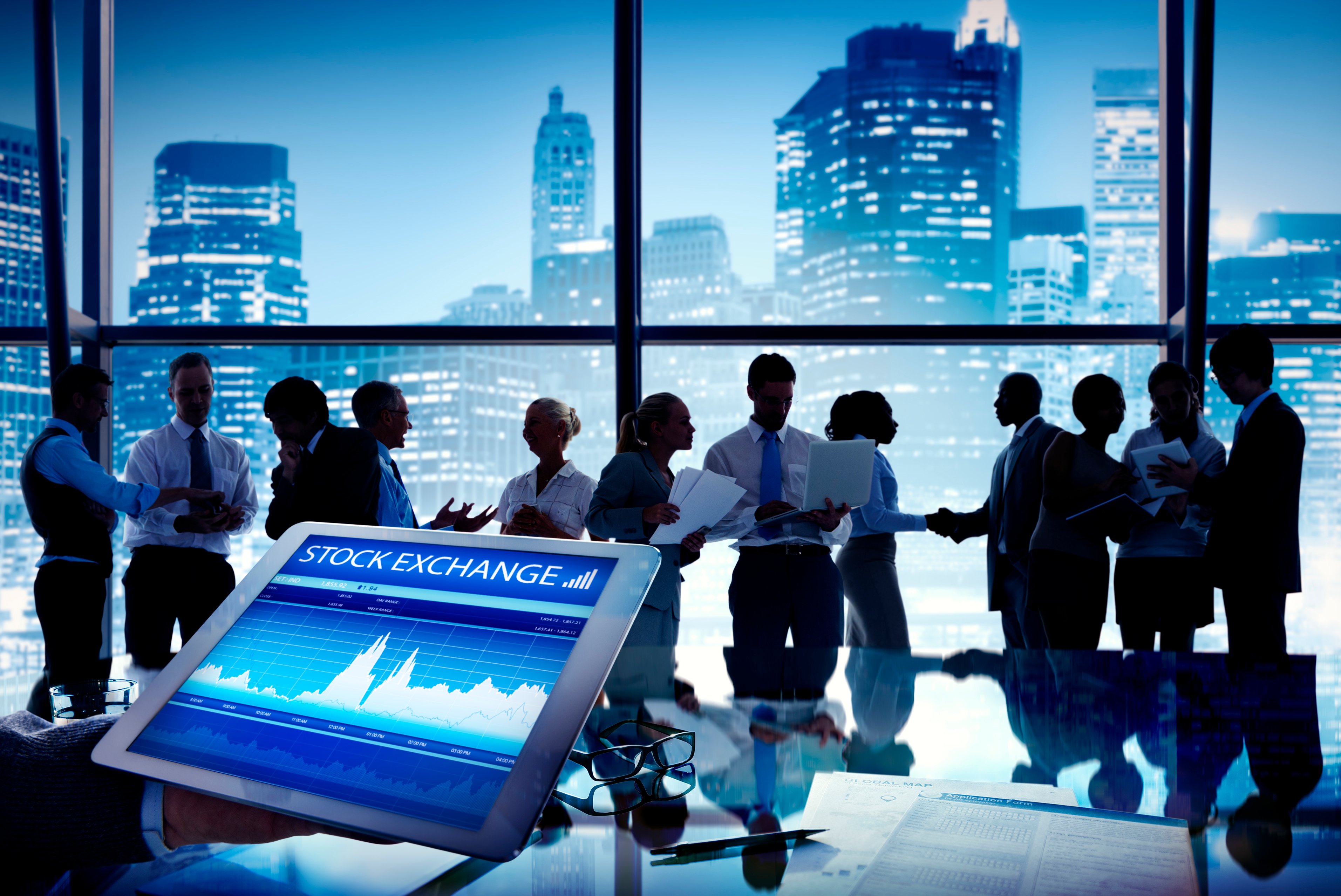People and stock display in front of skyline.