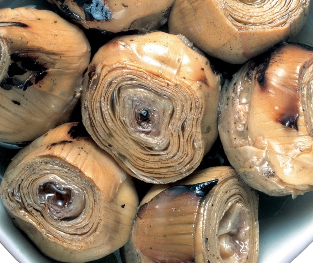 Artichoke hearts in a white bowl.