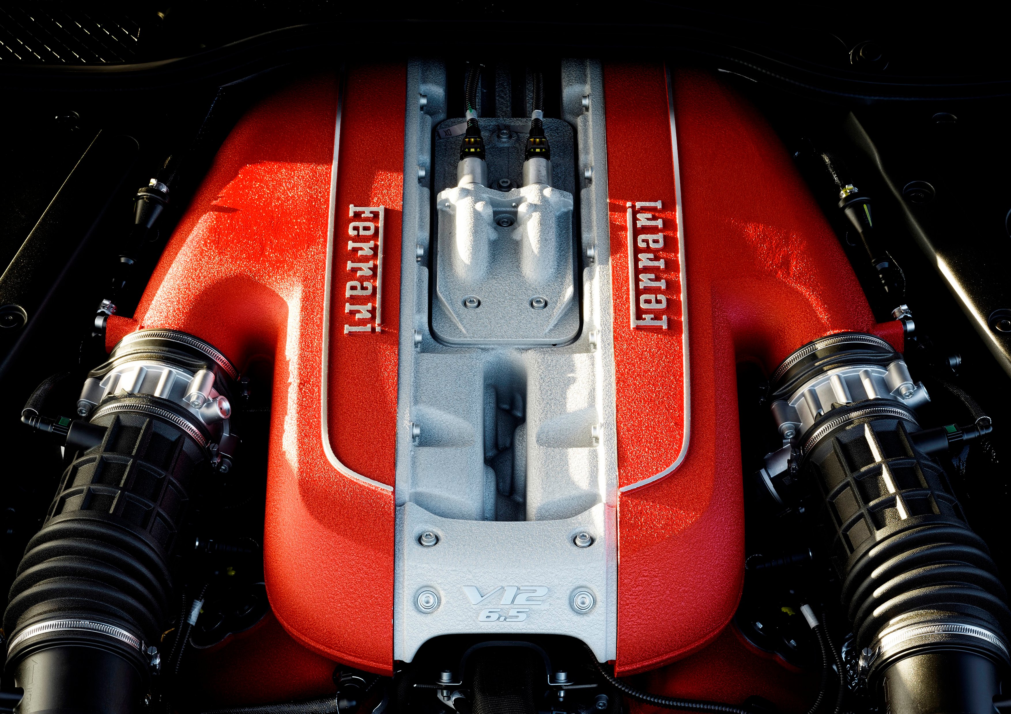 A look under the hood of an 812 Superfast, showing the shop of the car's 6.5 liter V12 gasoline engine.