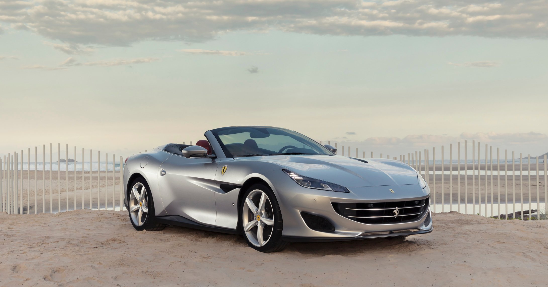 A silver Ferrari Portofino, a front-engined, four-seat convertible grand touring car.