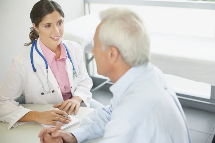 Doctor talking to patient at a table