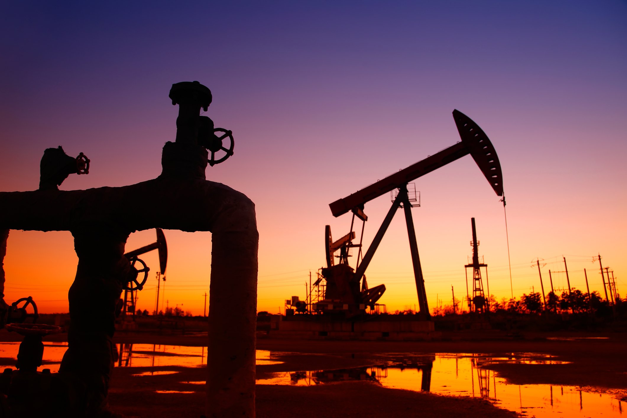 A pipeline and an oil pump at sunset
