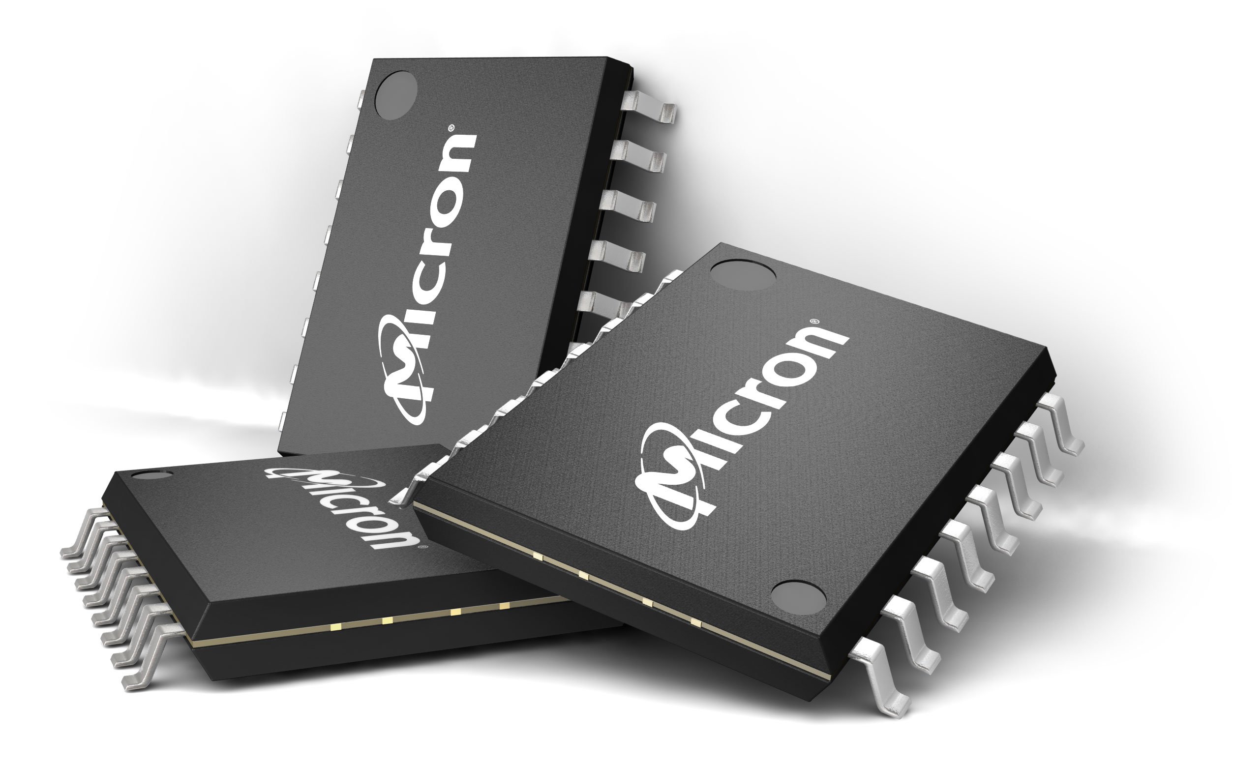 Three Micron memory chips on a white surface