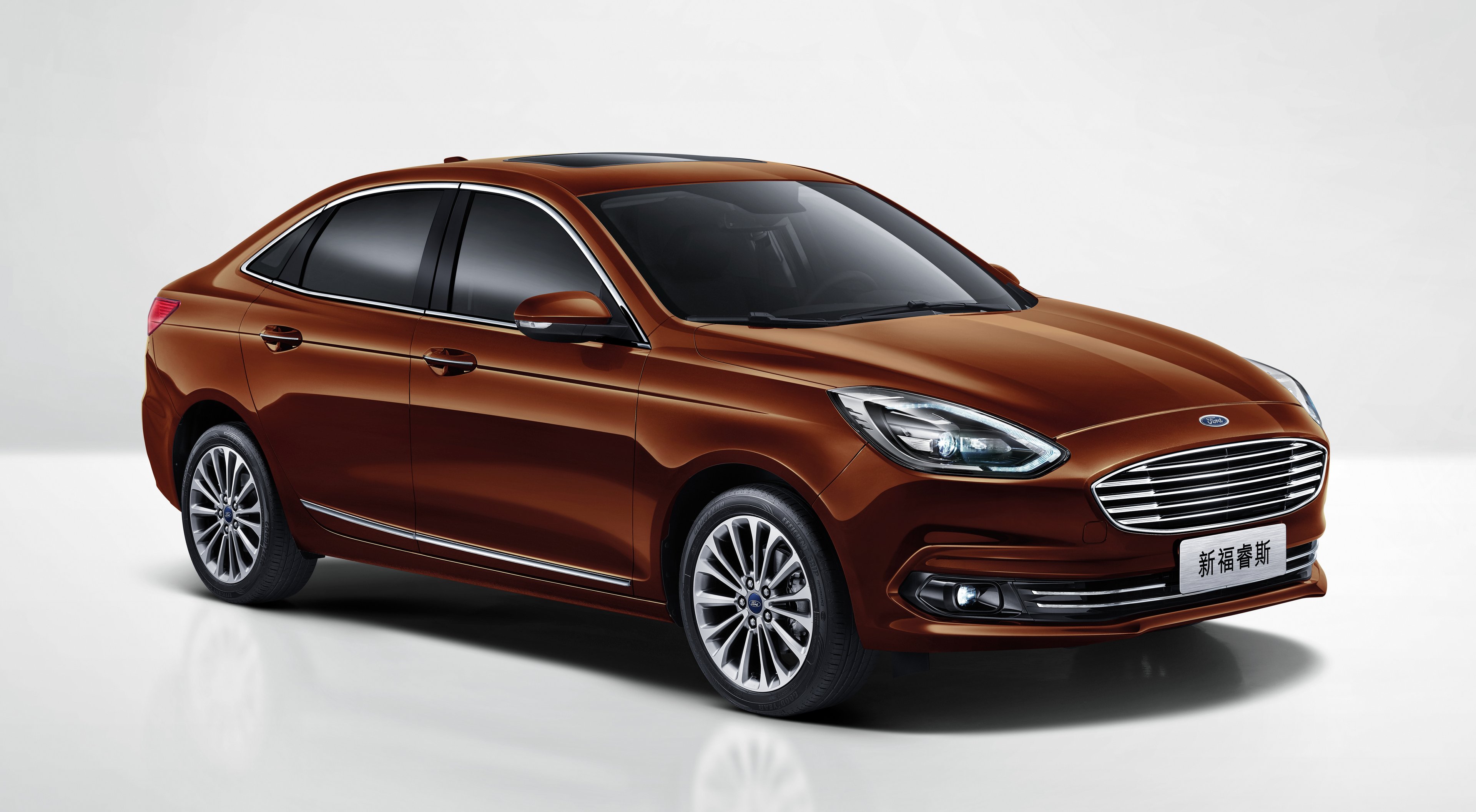 A brown 2018 Ford Escort, a compact sedan made for the Chinese market.